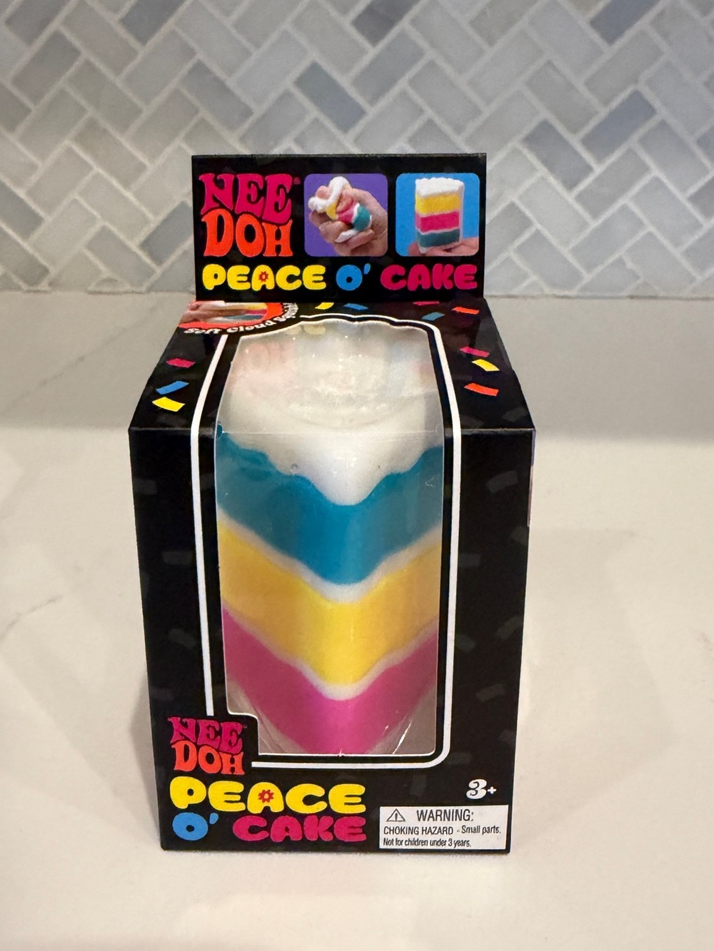 Nee Doh Peace O' Cake Multicolor Squeeze Toy - White, Blue, Yellow, Pink